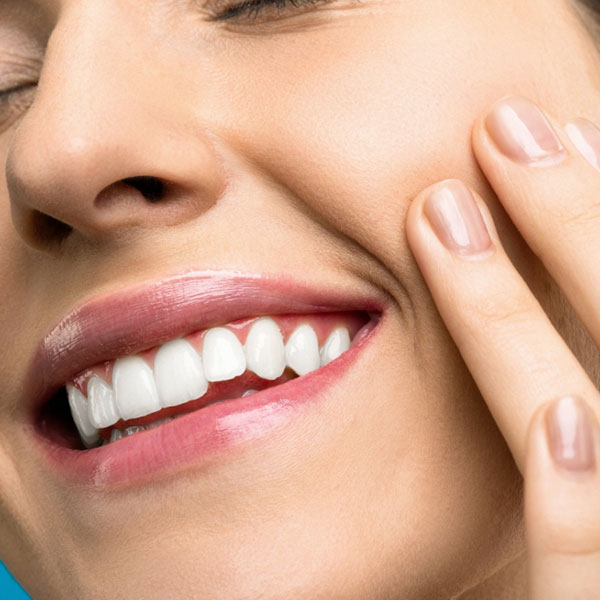 Dentist performing cosmetic dentistry on a patient